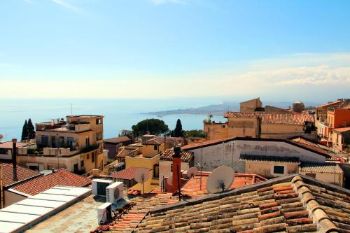 a view of a city from the roofs of buildings at Residence Circe in Taormina