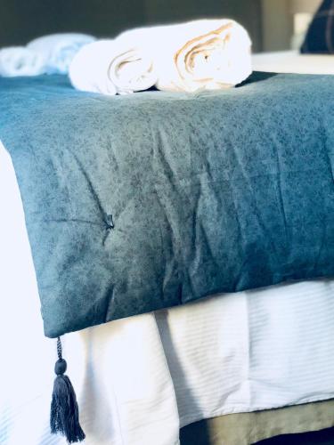 a bed with a blue blanket on top of it at Palazzina300 in Treviso