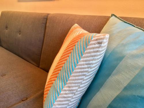 - deux oreillers installés au-dessus d'un canapé dans l'établissement Cannes Pool & Beach, à Cannes