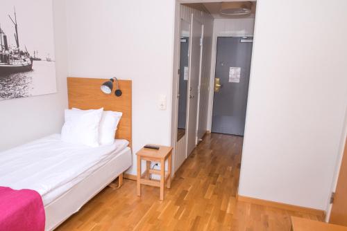 a small bedroom with a bed and a table at Best Western Plus Kalmarsund Hotell in Kalmar