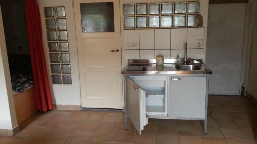 a small kitchen with a sink and a counter at studio-appartement in paardenstal in Colijnsplaat