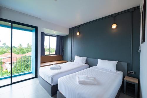Postel nebo postele na pokoji v ubytování S.22 Hotel Suratthani