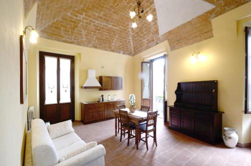 a living room with a couch and a table at Palazzo Centro Alloggi Vacanza in Nizza Monferrato
