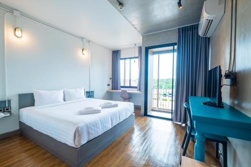Postel nebo postele na pokoji v ubytování S.22 Hotel Suratthani