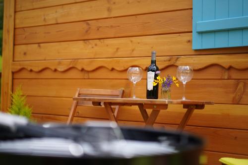 a table with two glasses and a bottle of wine at Coutillard in Parisot-Tarn-et-Garonne