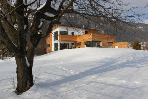 a house on top of a pile of snow at Seeidylle Winkler in Bodensdorf