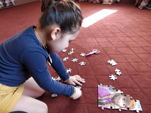 a young girl playing with legos on the floor at Panauti Homestay in Panauti
