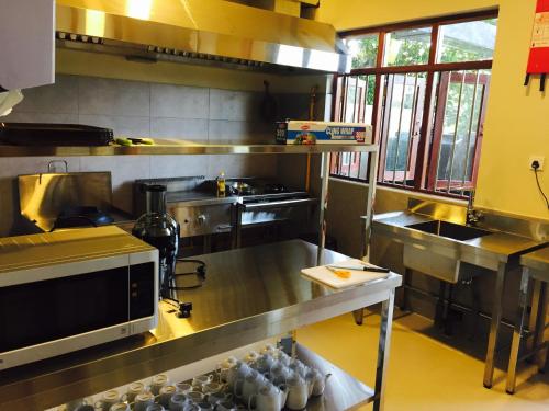 a kitchen with a large stainless steel counter top at Peacock Villa in Mirissa