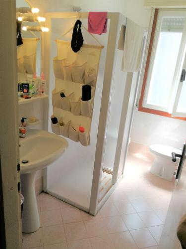 a bathroom with a sink and a toilet and a sink at Residence Solarium in Bibione