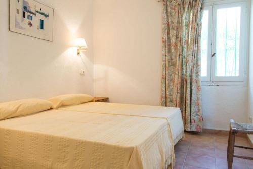 a bedroom with two beds and a window at Casa Lulu in Marbella