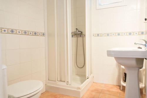 a bathroom with a shower and a toilet and a sink at Casa Lulu in Marbella