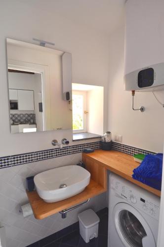 a bathroom with a sink and a washing machine at Stella Marina Amalfi Dreams in Ravello