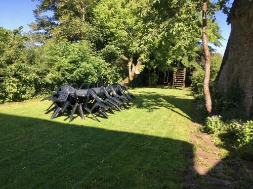 a group of tables and chairs in the grass at La grande maison de Carrouges in Carrouges
