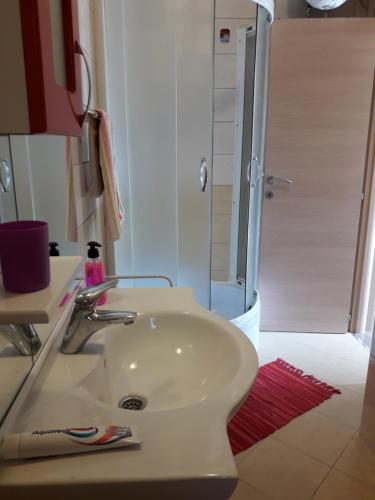 a bathroom with a sink and a shower at Luxury Apartment Maja in Tivat