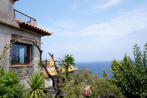 a building with a view of the ocean at Frictories station of residency in Limniónas