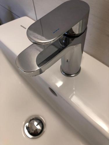 a bathroom sink with a faucet on a sink at La Dolce Vita studio with free private parking in Siena