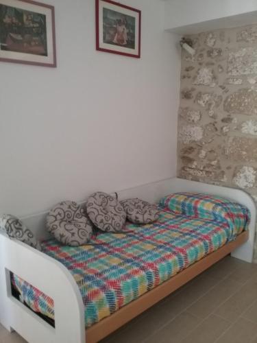 a bed with pillows on it in a room at Villa Magda in Makrádes
