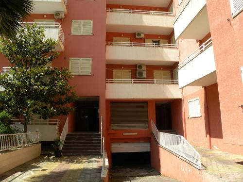 an apartment building with stairs in front of it at Apartment Soleal Orikum in Orikum
