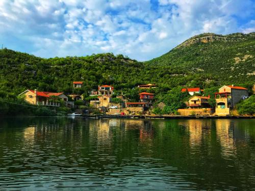 a group of houses on the shore of a lake at Studio Apartment Cudo Nevidjeno in Karuč