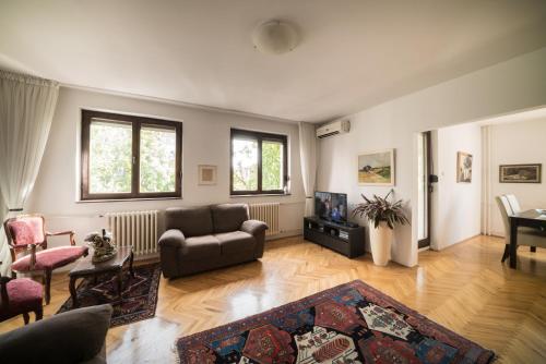 a living room with a couch and a table at Sensitive Apartment in Belgrade