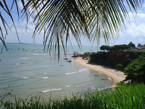 a view of a beach with boats in the water at Casinhas Vila Bonita Hobbit in Baía Formosa