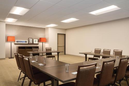 a conference room with tables and chairs and lights at Country Inn & Suites by Radisson, Lawrence, KS in Lawrence
