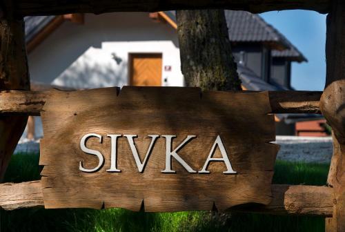 a sign that says swka on a wooden fence at Apartments Sivka - Private Sauna in Cerklje na Gorenjskem