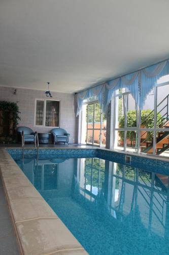 a large swimming pool with blue water in a house at Гостевой дом Райское Местечко in Lazarevskoye
