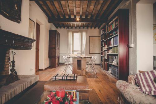 a living room with a table and chairs in it at La Luna nel Pozzo in Parma