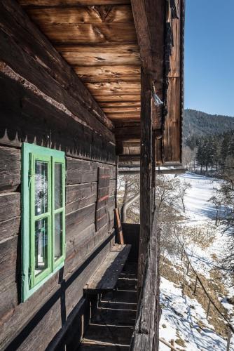an outside of a log cabin with a green window at Urlaub auf der Alm "Deluxe" in Preggraben
