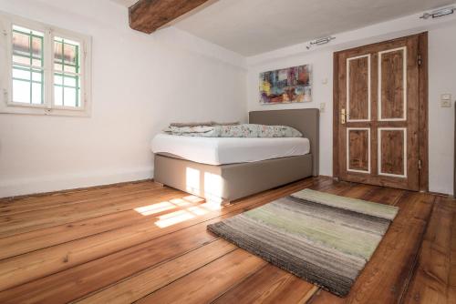 a bedroom with a bed and a wooden floor at Urlaub auf der Alm "Deluxe" in Preggraben