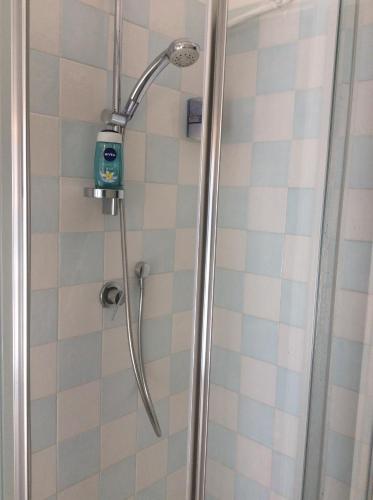 a shower with a shower head in a bathroom at Casa Giulia In in Pisa