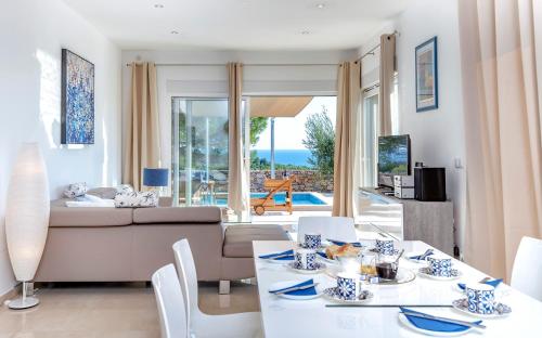 a living room with a couch and a table and chairs at Villa Moderna Family Friendly in Hvar