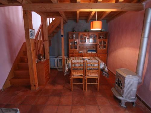 a dining room with a table and a stove at Casa Azul in Nazaré