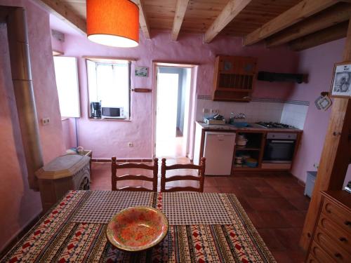 a kitchen with a table with a bowl on it at Casa Azul in Nazaré