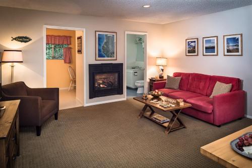 a living room with a red couch and a fireplace at Trinidad Inn in Trinidad