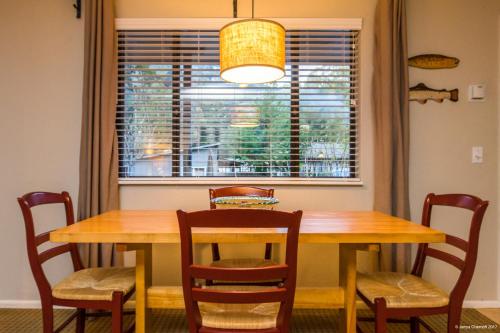 a dining room table with chairs and a window at Trinidad Inn in Trinidad