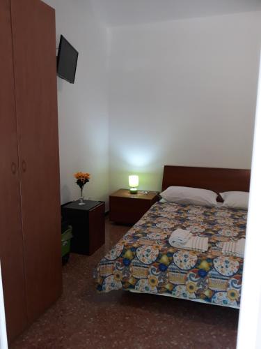 a bedroom with a bed and a lamp on a table at Venice Best Vacation in Marghera