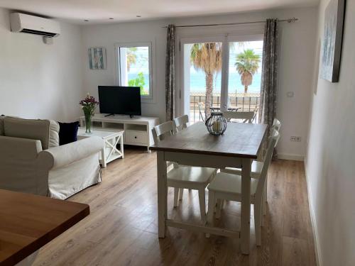 a living room with a table and a couch at Vilamarlux II in Vilassar de Mar
