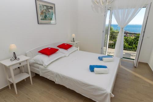 a bedroom with a bed with a view of the ocean at Apartment Veve in Privlaka