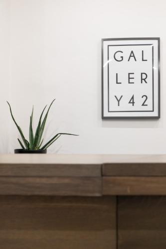 a plant sitting on top of a dresser with a picture at The Gallery 42 Guest House in Florence