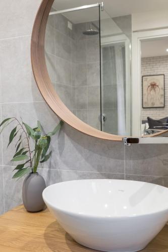 a bathroom with a white sink and a mirror at The Gallery 42 Guest House in Florence