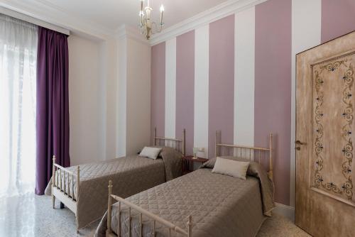 Giường trong phòng chung tại Villa Alemi'