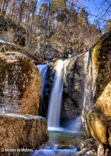 a waterfall in the middle of a river with rocks at El Mirador de Molinos in Molinos de Duero
