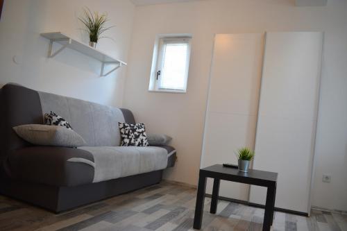 a living room with a couch and a table at Apartments Milas in Trogir