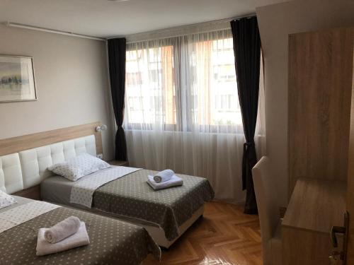 a hotel room with two beds and a window at Leo in Niš