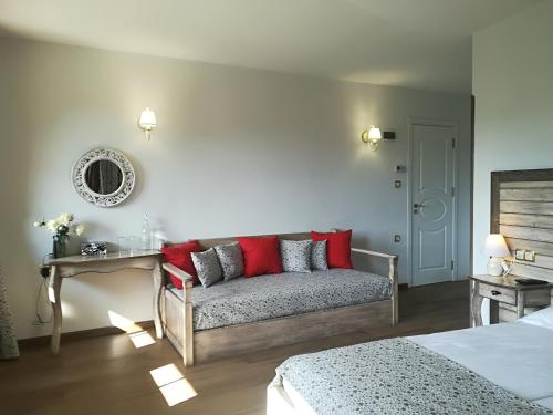 a living room with a couch with red pillows at Manoleva House in Melnik