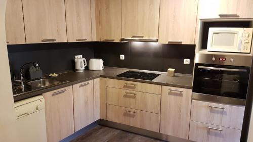 a kitchen with a sink and a stove top oven at Casa da Camacha in Porto Santo