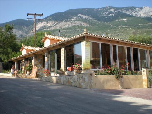 a building with a mountain in the background at Maria Apartments in Lourdhata