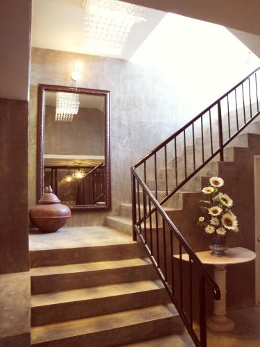 a hallway with a staircase and a mirror at G2 Boutique Hotel in Chiang Mai